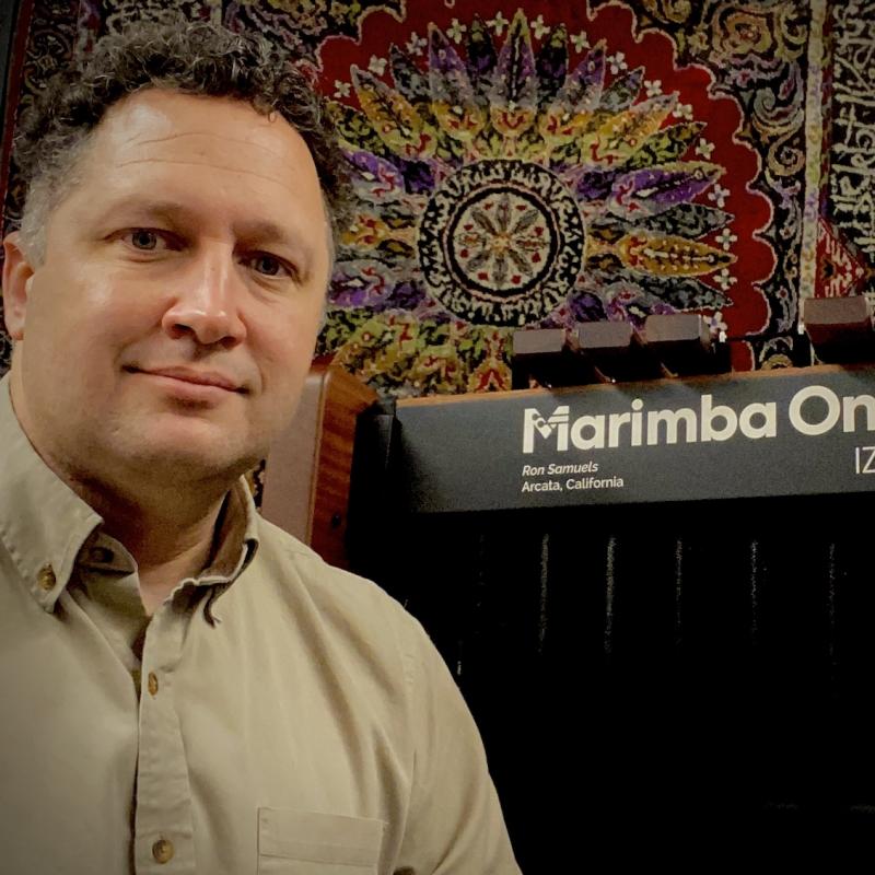 Dr. Stefan Ice next to a Marimba One marimba